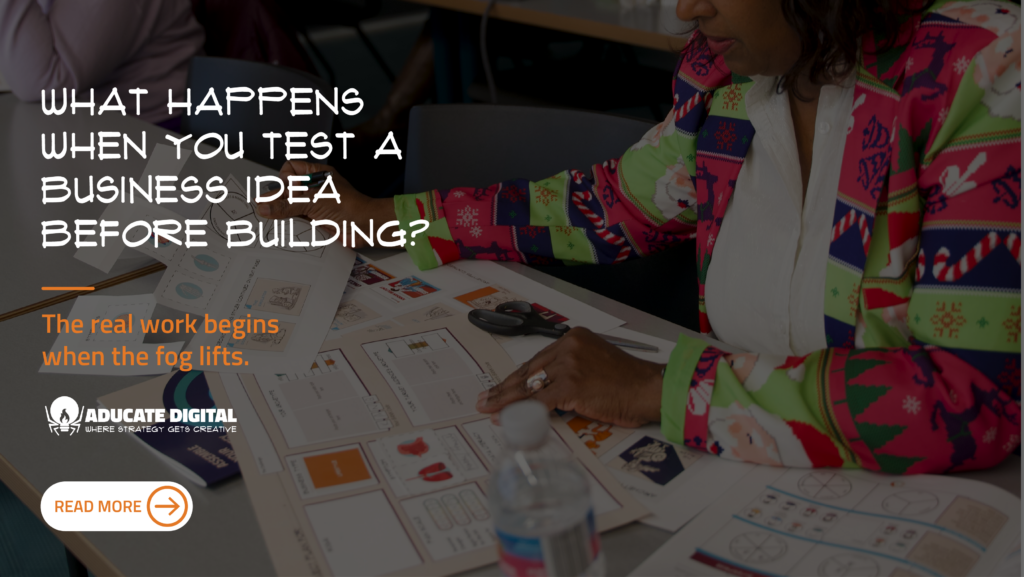 Workshop attendee sitting at a table, writing in a workbook during an Aducate Digital workshop, actively working through a business idea.