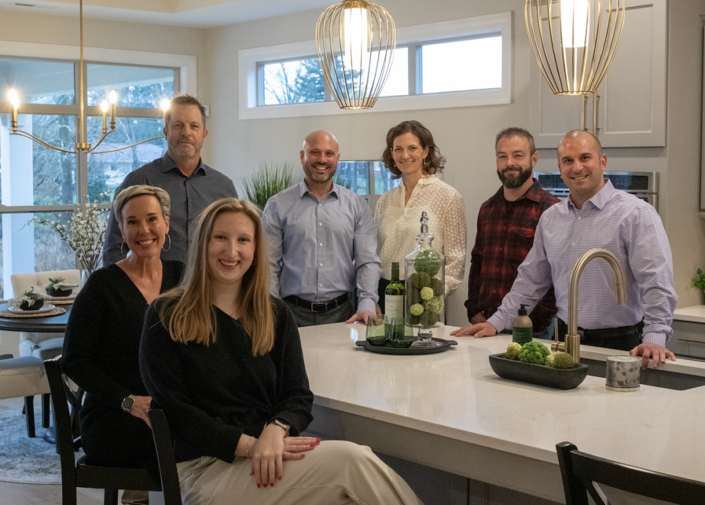 The New Leaf Homes team posing in a beautiful kitchen